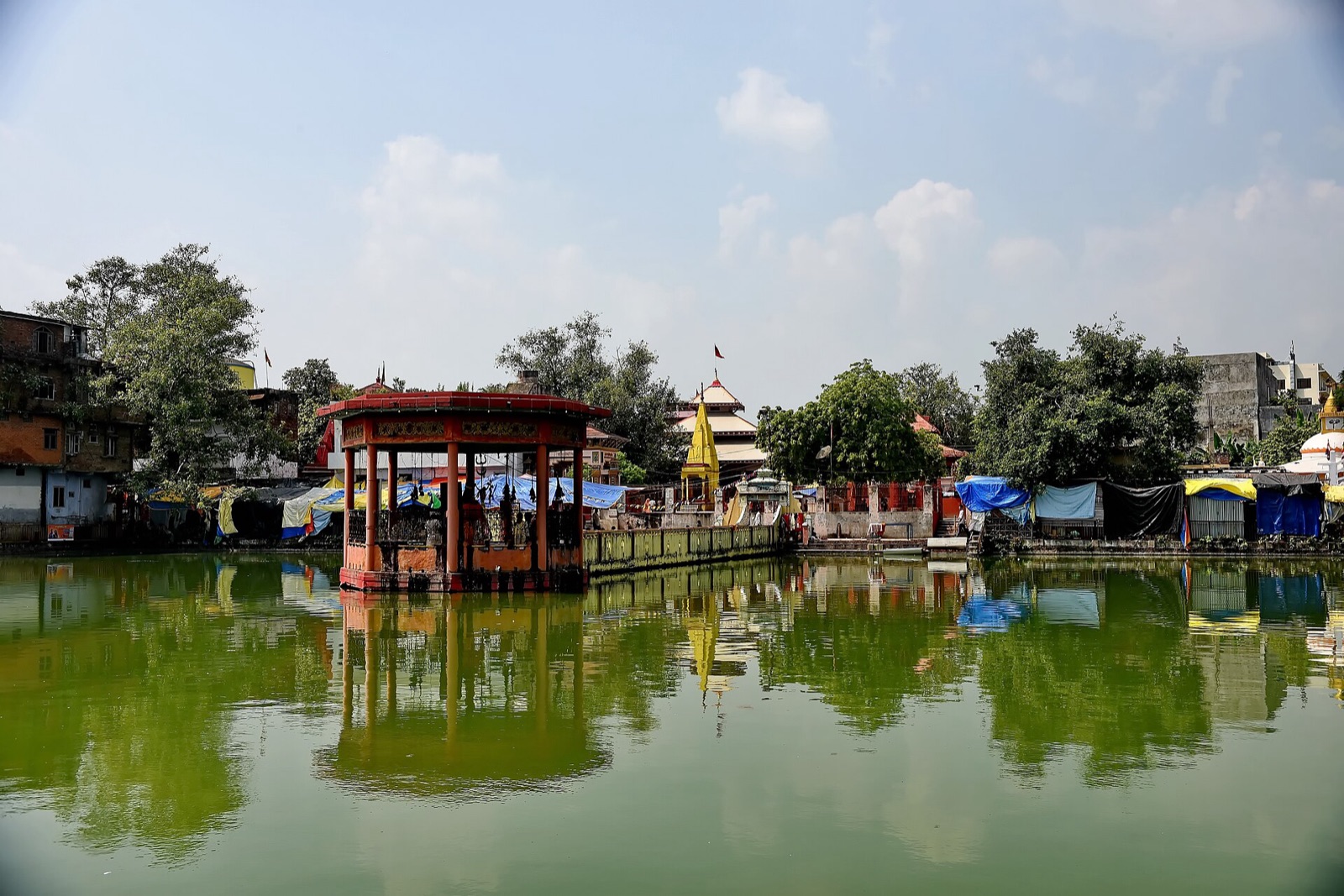 The Bageshwori Temple in Nepalgunj reflected in the sacred Rani Talab pond, its red pavilion standing in the water